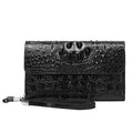 Black crocodile skin clutch bag on a white background