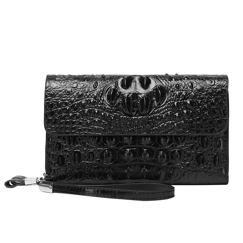 Black crocodile skin clutch bag on a white background